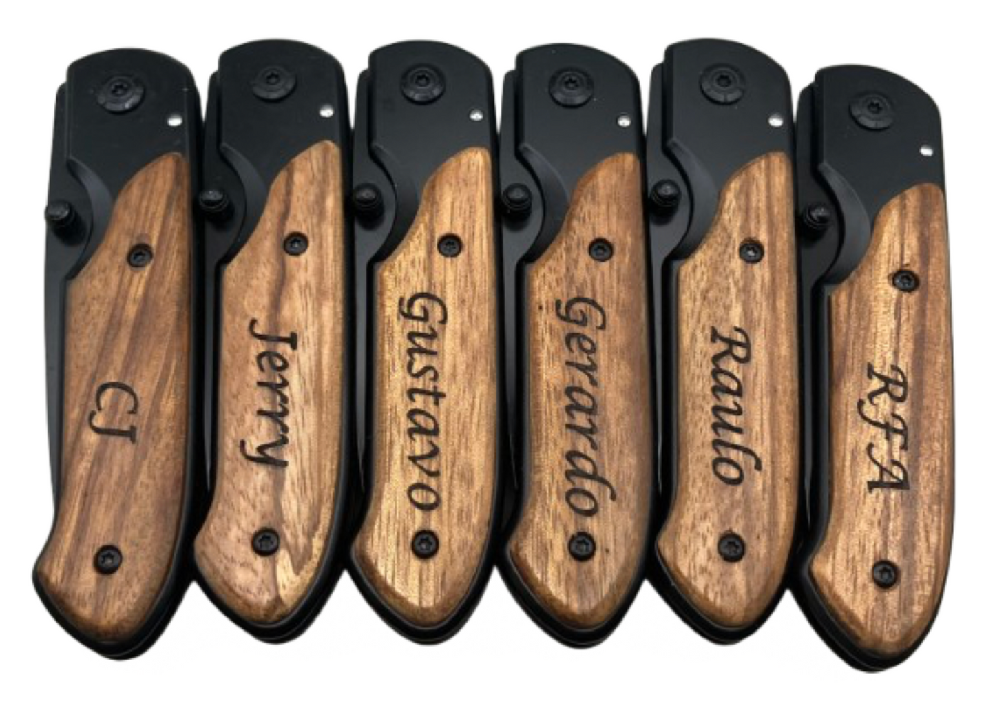 Six engraved knives with wood handle, shown closed, designed for a group christmas gift. The handle features a custom engraving reading 'CJ, Jerry, Gustavo, Gerardo, Raulo, and RFA' on it.
