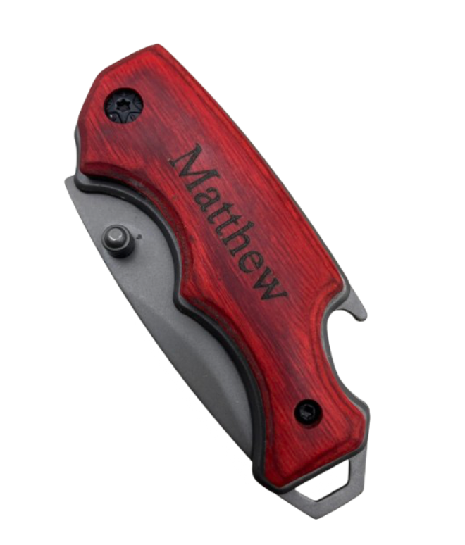 Premium folding pocket knife with grey blade and custom-engraved wooden handle. Features include bottle opener, hanging clip, and ergonomic design. This listing image displays the knife with closed blade and the personalized engraving of "Matthew" in Times New Roman font.
