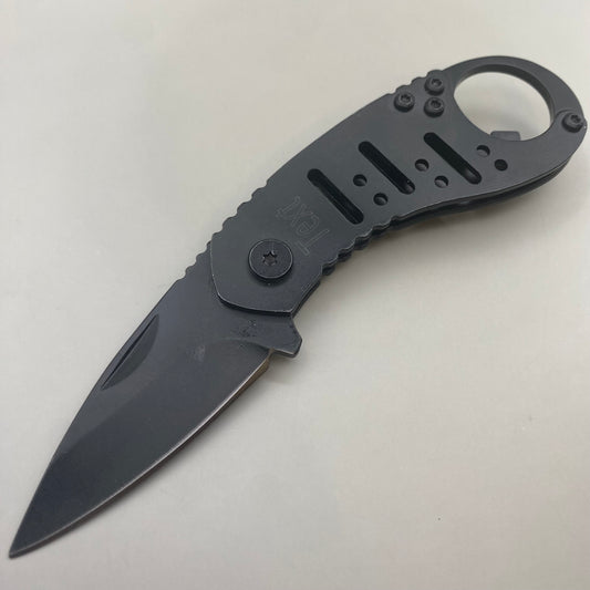 Personalized engraved black folding pocket knife with circular clip and bottle opener. Handle features 'Text' engraving.