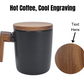 Custom engraved black stoneware mug with a wood handle and matching lid. Personalized design on the wooden lid, perfect for gifts or coffee lovers.